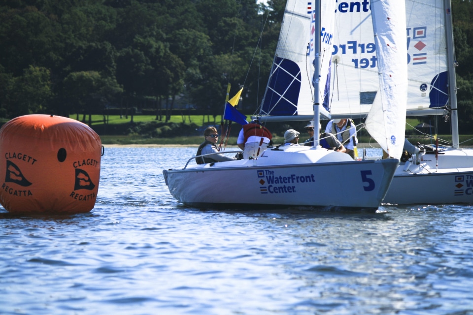 Kevin_Holmberg_and_crew_with_Charlie_Rosenfield_in_background_at_2018_Clagett-Oakcliff_Match_Race_Clinic_and_Regatta_credit_Francis_George.JPG