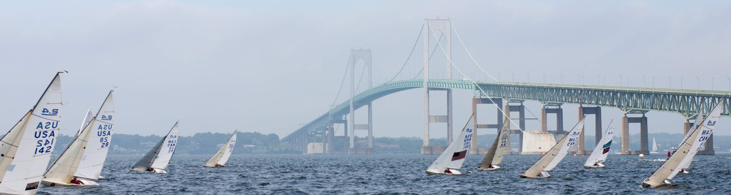 The Clagett fleet of 2.4mRs sail upwind with the Newport Bridge in the background