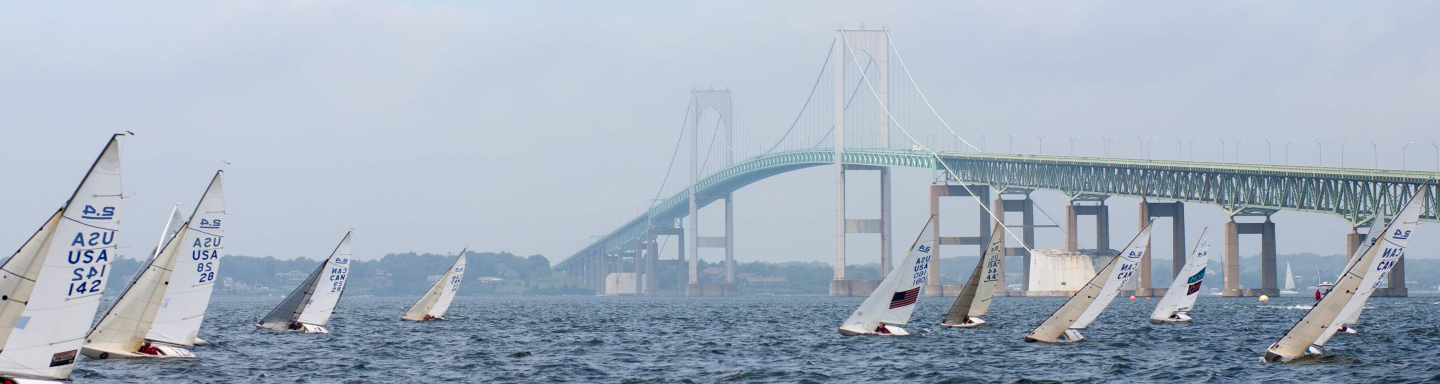 The Clagett fleet of 2.4mRs sail upwind with the Newport Bridge in the background